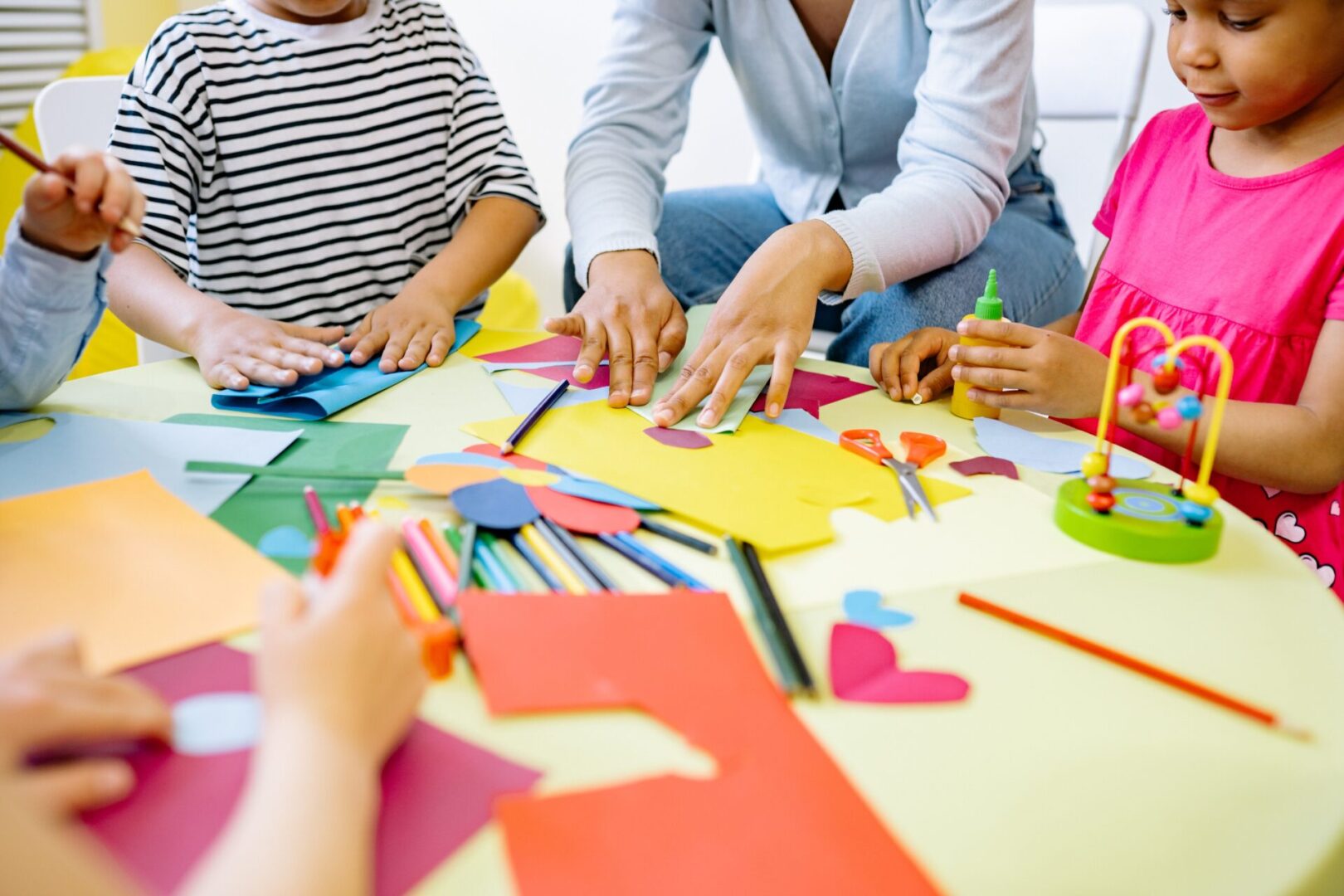 A group of people sitting around a table with paper.