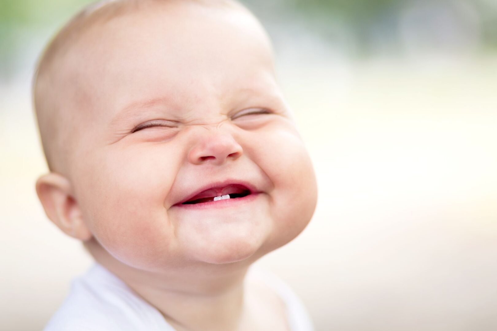 A baby smiling with its mouth open.